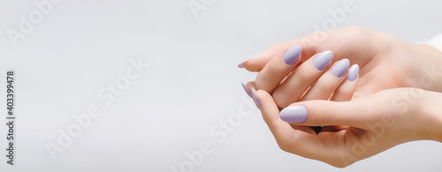 Female hands with rose nail design. Pink glitter nail polish manicure on white background. Nail design copy space.