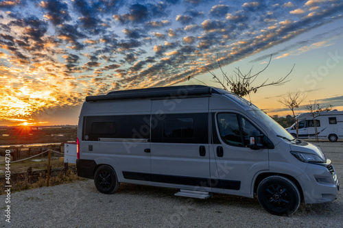 beautiful sunset on the coast of Andalusia with camper van and RV at campground during holidays