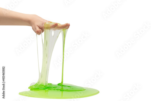 Green slime toy in woman hand isolated on white background.