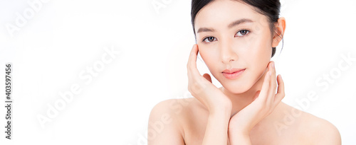 Closeup portrait of beauty asian woman with fair perfect healthy glow skin hand touching cheek isolated on white, young beautiful asia girl with pretty smile on face. Beauty korean spa skincare banner