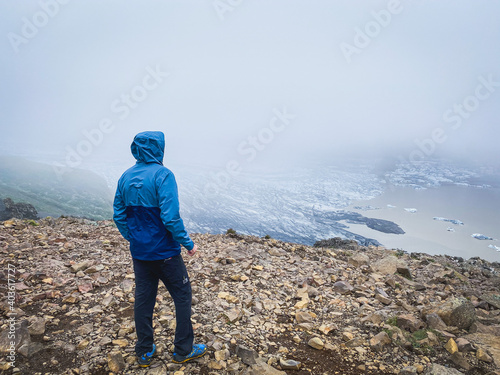 Mountaineer on the top of a glacier with foggy views in Iceland.
