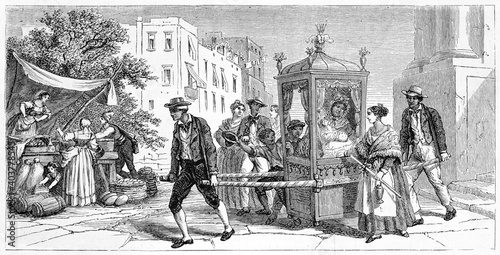Rich woman transported outdoor by sedan chair along Naples streets, Italy, surrounded by everyday life. Ancient grey tone etching style art by Ferogio, Le Tour du Monde, 1861