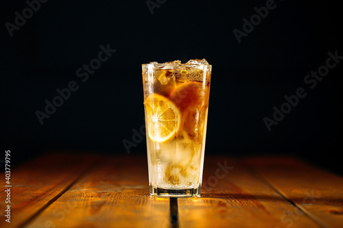 Fresh fizz long island ice tea cocktail in a glass on the wooden table