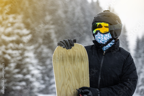 Young girl snowboarder holding her snowboard