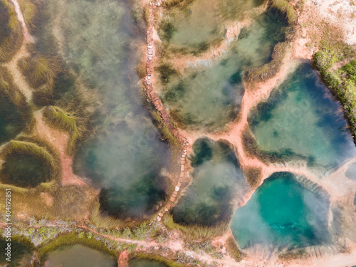 Aerial top down view of beautiful nature abstract crystal clear emarald pool during sunrise