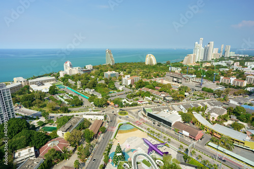 Pattaya city at chon buri in thailand on blue sea or ocean and home resort or hotel and construction site by real estate business with road and roundabout on nature green tree for travel on clear sky