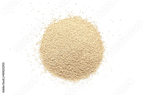 Pile of dry yeast isolated on white background, top view. Active dry yeast on a white background, top view. Dry yeast granules isolated on white background. Dry yeast is used in baked goods.