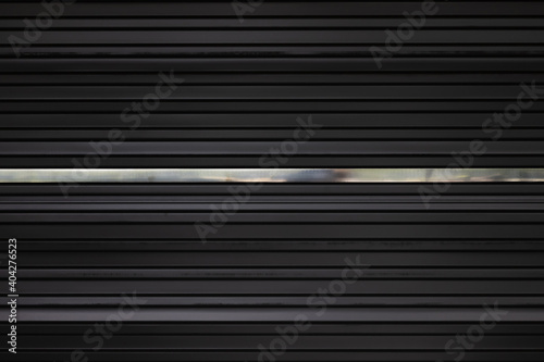black metal shutter door with silver stainless line. black steel panel black steel panel