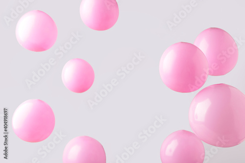 Pink pastel baloons on grey background. Minimalism