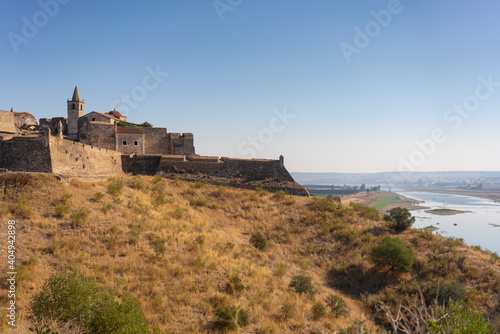 Juromenha castle and Guadiana river and border with Spain on the side of the river at sunrise, in Portugal