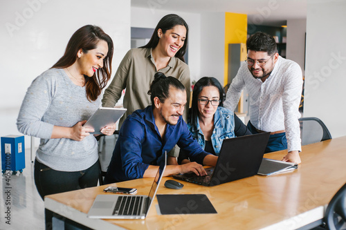 Group of latin business people working together as a teamwork while sitting at the office desk in a creative office in Mexico city