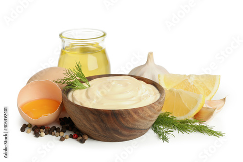 Bowl of mayonnaise and ingredients for cooking isolated on white background