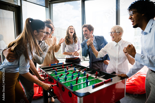 Colleagues playing table football in the break.