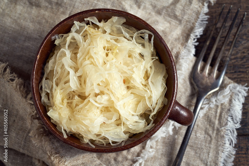 Fermented cabbage in a pot on a table, top view