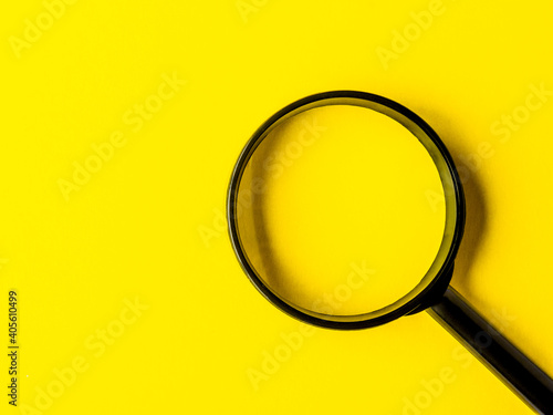 magnifying glass magnifier loupe search symbol on yellow background with copy space