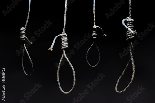 Horror photo of a dark scary hanging nooses on black background.