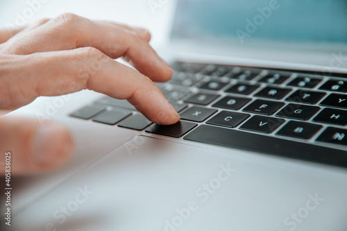 close up. man pressing the command key on his laptop.