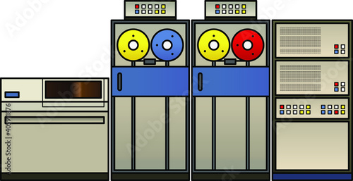 A retro mainframe computer setup with a processor cabinet, classic tape drives, and a fixed disk drive,