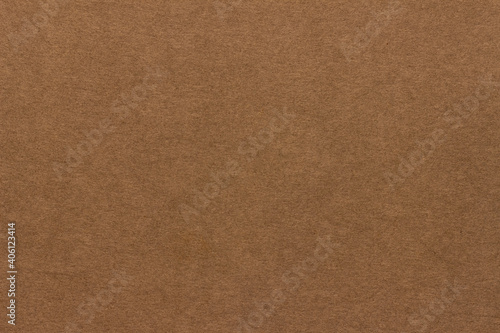 Light brown cardboard texture. Uniform beige background with small inclusions.