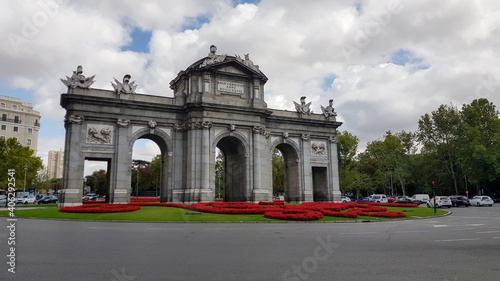 Puerta de Alcala Neo-classical gate in Madrid during day with traffic