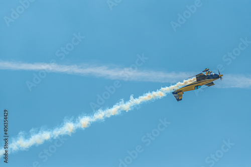 The aerobatic plane with smoke track in the sky