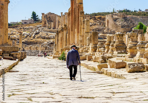 Jordan, the ruins of Jerrash (Gerasa). Old man is visiting and walking in the colonnaded street. 