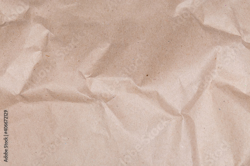 Background of gray brown slightly crumpled wrapping paper, fragment, texture