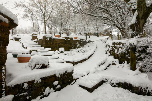 Heavy snow covers traditional Dales cottage driveway and entrance on the moorland smallholding after daylong snowfall in Nidderdale