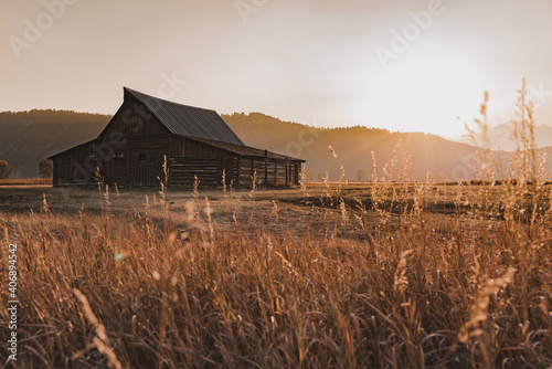 old barn at sunset and teton mountains 