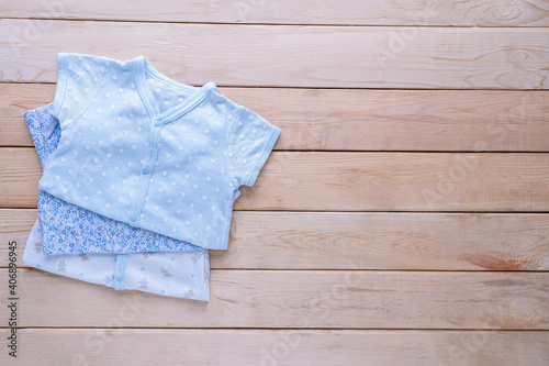 The clothes for kids for babies set on the wooden table.