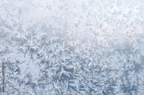 Cold frost patterns on window glass. Winter texture