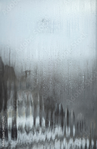  Misted glass. Condensation droplets and icing on the glass. Thaw. Thaws the glass.