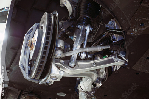 A modern car on a lift in a car service, the wheel is removed from the car, structure and suspension elements of a modern car.