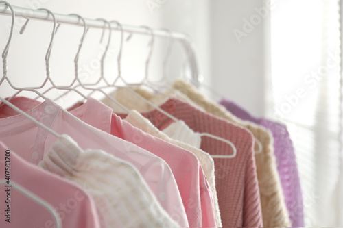 Rack with stylish women's clothes indoors. Interior design