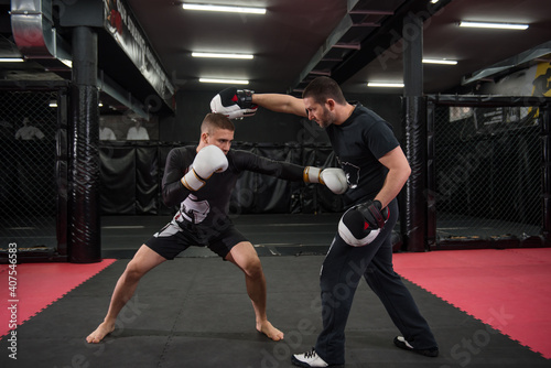 Male fighter training with his trainer