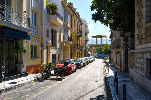 View from a quiet street as traffic passes by The Arch of Hadrian, known in Greek as Hadrian's Gate in the historic center of Athens, Greece