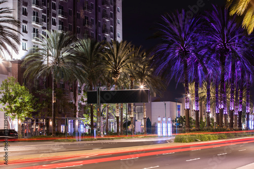 Long exposure night view of traffic passing along a street in downtown Anaheim, California, USA.