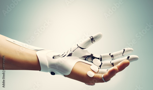 Robotic bionic hand connected with human hand.