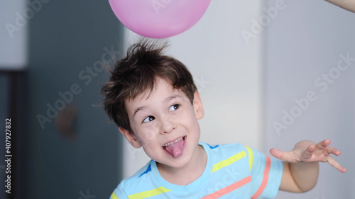 surprised cheerful boy with thorns in his hair without static electrification. Physics, electrical electrification balloon test. Positively and negatively charged atoms. School lesson experiment.