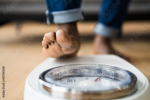 African Man Feet Standing On Weight Scale