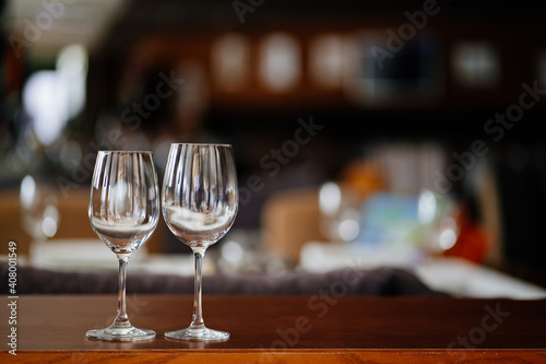 two empty clean wine glasses on a wooden table. utensils for alcoholic beverages. serving the table.