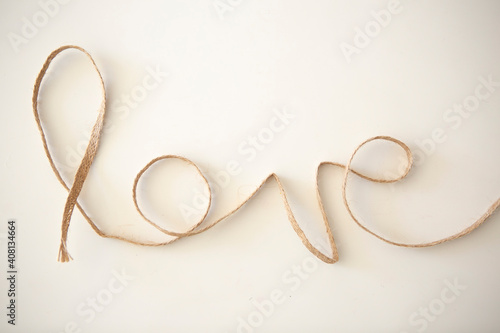 Word "love" made with rope on white background