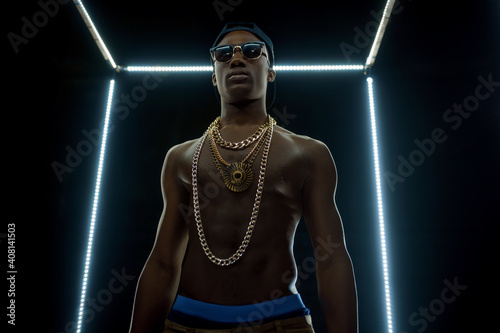 Serious rapper in gold chains, bottom view