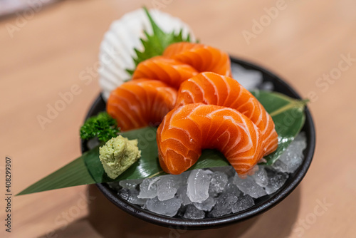 Salmon sashimi in bowl alose up