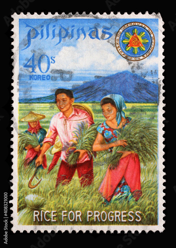 Stamp issued in the Philippines shows President and Mrs. Marcos harvesting miracle rice, Series: Rice for Progress, circa 1969