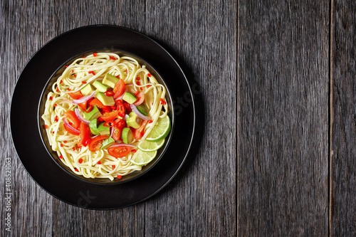 pasta with avocado, tomatoes and lime, top view