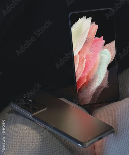 Two smartphones placed on an armchair.