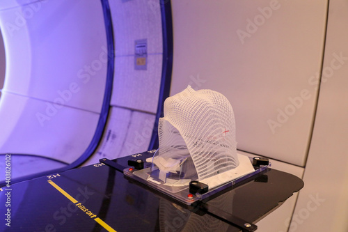 Patient Radiation proton therapy fixing mask showing laser lines for targeting cancer cells in the brain