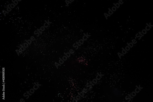 Stardust from fireworks in the black sky 