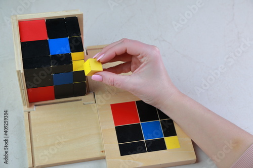 Montessori binomial and trinomial cubes 